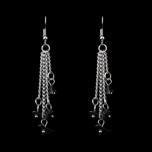 Detailed view of silver chain tassels with black natural stone beads on drop earrings