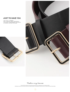 Detail view of flat wide leather belts in black and burgundy with large gold square buckles