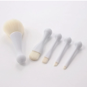 Detail of 5-piece portable lollipop makeup brush set with spiral white handles