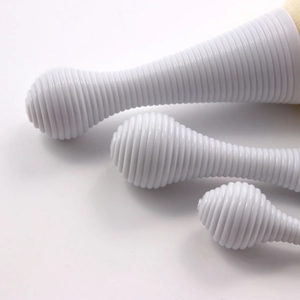 Close-up of portable lollipop-shaped makeup brush set with white threaded plastic handles
