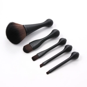 Detailed view of 5 makeup brushes with black spiral handles and soft gradient bristles