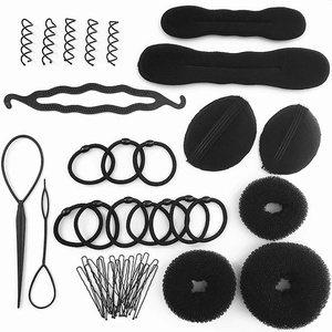 All-in-one black hairstyling kit with sponge buns, hair donuts, pins, and tools on white