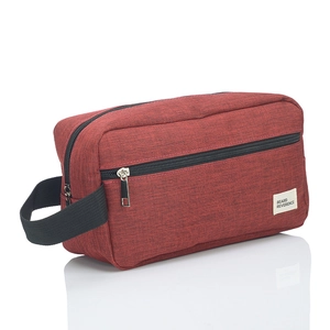 Close-up of red oxford fabric toiletry bag with black zipper and Beard Reverence label