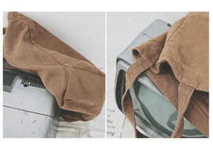 Detail view of large brown canvas tote bag with shoulder strap in vintage style