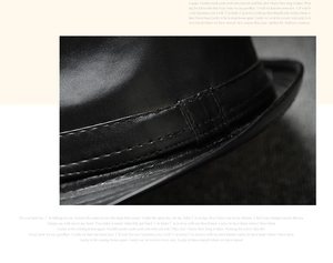 Close-up of black PU leather fedora showing fine grain texture and double-stitched brim seams