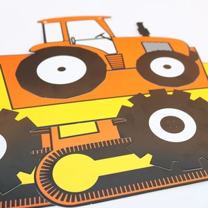 Detail of cartoon orange tractor and yellow bulldozer cutouts for birthday party decor