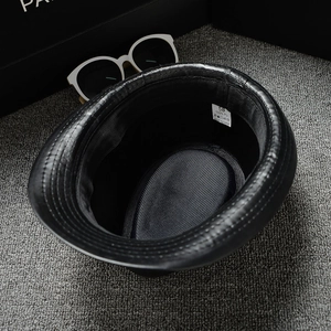 Top view of black PU leather jazz hat showing internal size 58 label and sweatband details