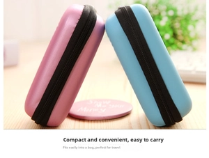 Close-up of pink and blue portable EVA hard shell cases for earbuds and data cables