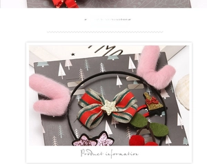 Detail of Christmas headband with pink plush reindeer antlers and festive ornaments
