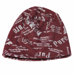 Detail of burgundy knit beanie featuring silver printed letters and soft ribbed texture