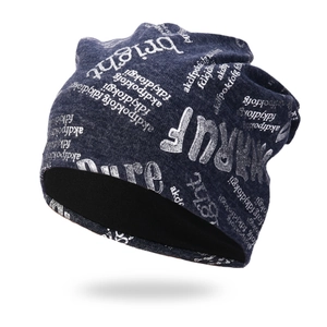 Deep blue knit beanie with silver letter prints in a 45-degree angle street style view