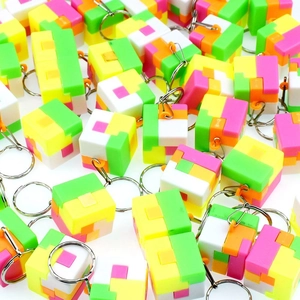 Close-up of colorful 3D puzzle cube keychains with vibrant plastic modules and metal rings