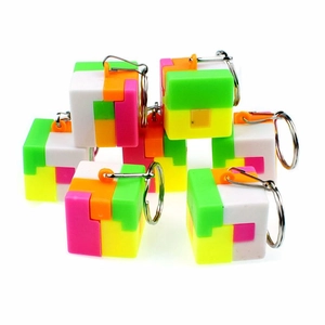 Detail of colorful puzzle cube keychain showing neon plastic modules and metal ring