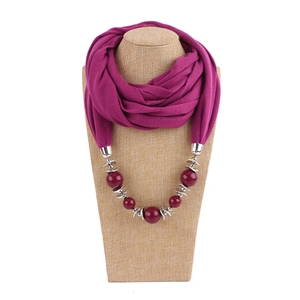Detail of fuchsia neck scarf necklace with metallic chain and colorful bead ornaments
