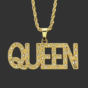 Macro shot of gold twist chain necklace with rhinestone encrusted QUEEN letter pendant