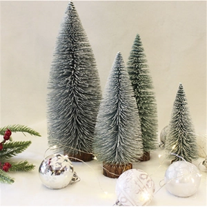 Frosted mini Christmas trees with silver ornaments and LED lights on wooden bases