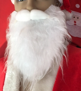 Close-up of fluffy white faux fiber Santa beard set with red plush holiday costume