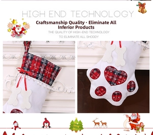 Close-up of dog paw Christmas stocking with red black plaid pattern on a white fireplace