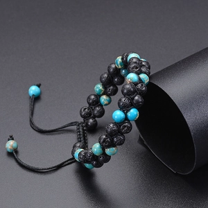 Macro detail of double-layer braided bracelet with black lava stone and blue turquoise beads