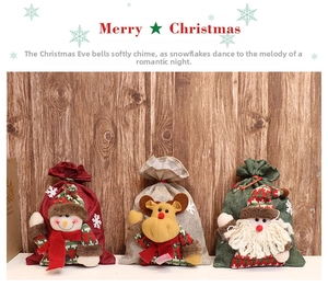 Three Christmas burlap drawstring bags with 3D snowman, reindeer, and Santa plush figures