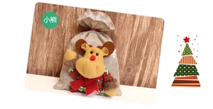 Detail of Christmas burlap gift bag featuring a 3D reindeer doll with drawstring closure