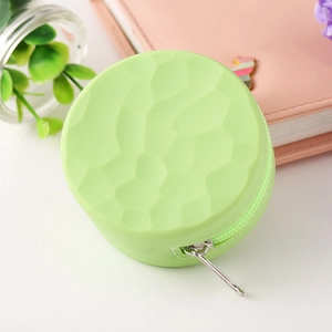 Light green round silicone coin purse with geometric texture and secure zipper