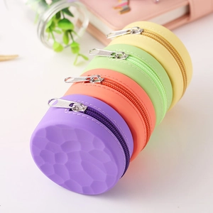 Close-up of colorful silicone coin purses with textured surface and metal zippers