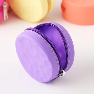 Close-up of a purple silicone coin purse with honeycomb texture and secure zipper closure