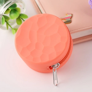Round coral orange silicone coin purse with honeycomb texture and metal zipper
