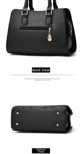 Detail view of the black textured leather handbag back zipper and protective bottom studs