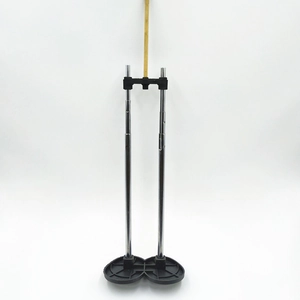 Detail of adjustable telescopic metal rod with plastic base and wooden top support