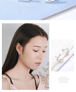 Detailed view of cutout cat shape silver earrings on model and close-up product macro