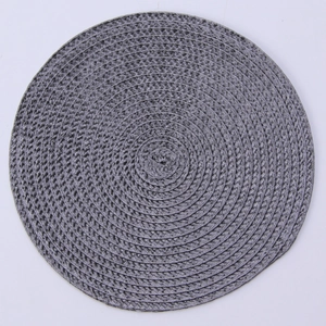Detailed top view of a circular gray woven place mat showing concentric fiber textures