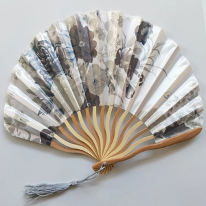 Detailed view of Japanese style silk folding fan with floral pattern and grey tassel