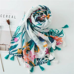 Cotton linen floral scarf with tropical green leaves and colorful tassels for beach vacations
