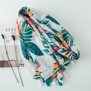 White cotton linen scarf with tropical green leaf print and colorful tassels for beach