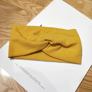 Ginger yellow knitted headband with twisted knot design in a minimalist Korean style