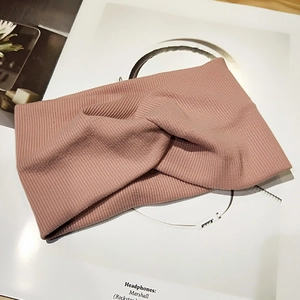 Macro view of mauve knit headband featuring ribbed texture and stylish knot detail