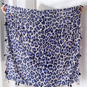 Detailed macro shot of the leopard print cotton linen scarf with blue frayed tassels