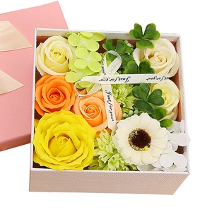 Soap flower gift box with yellow roses and white ribbon in a textured white box