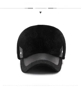 Detail of warm black faux fur baseball cap with leather trim and metal rivets
