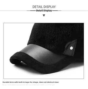 Detailed view of black faux fur baseball cap with leather trim and silver metal rivet
