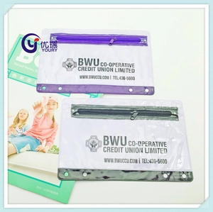 Macro detail of transparent PVC zipper pouch showing binder holes and custom logo print