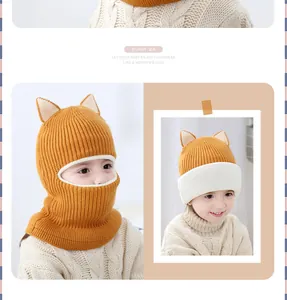 Detail of ginger knitted baby balaclava with cream trim and cute animal ears design