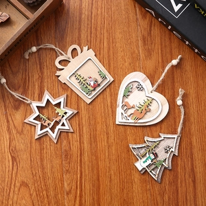 Set of 4 laser-cut wooden Christmas ornaments with Santa and reindeer on wood table