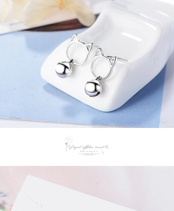 Detailed view of cat shape silver earrings with hanging bell charms for women