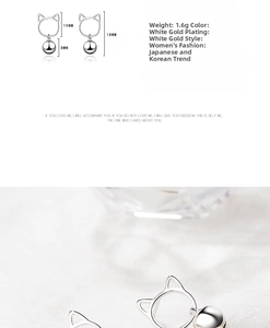 Macro detail of cat-ear shaped silver earrings with bell charms and 18mm length