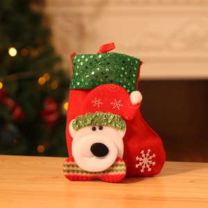 Detailed view of red Christmas stocking with white 3D bear doll and green sequins
