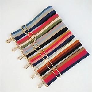 Parallel layout of colorful striped fabric bag straps with golden metal buckles