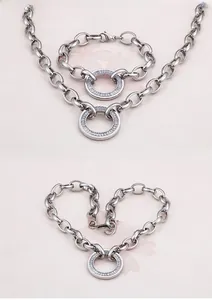 Detailed view of silver thick link chain jewelry set with cubic zirconia ring pendant